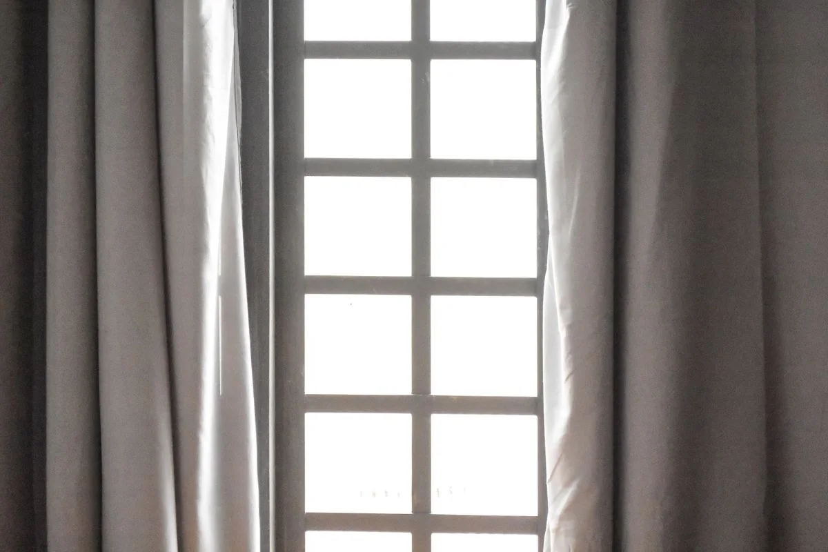 An elegant window with sheer curtains, capturing natural light and calm ambiance.