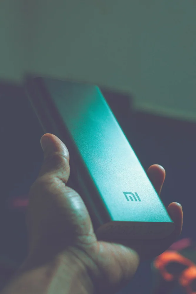 Close-up of a hand holding a Mi power bank, showcasing portable charging technology.