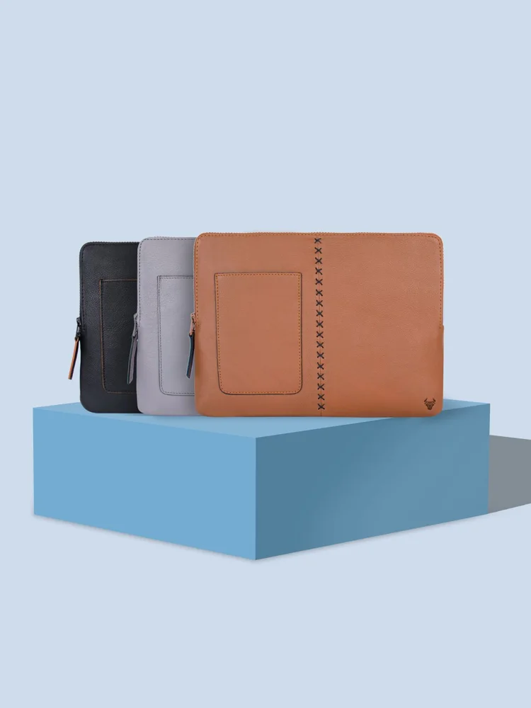 Three stylish leather laptop sleeves in different colors highlighted against a blue background for protection and style.